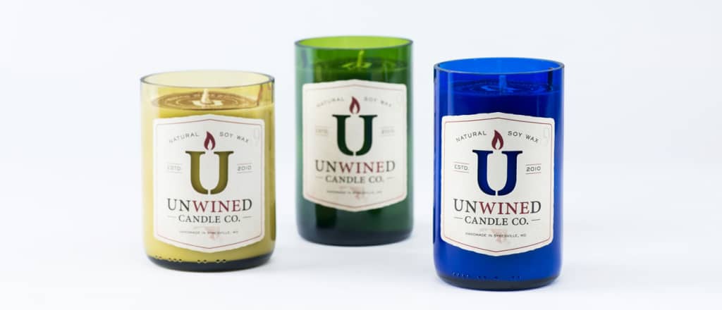 Yellow, green, and blue Unwined Candles in recycled wine bottles.