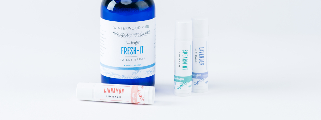 Skincare products, including lip balm tubes, with crisp white labels.