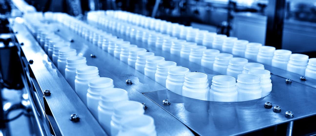 Empty bottles ready to be filled with product on a production line.