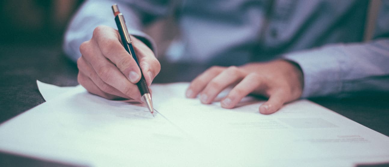 A businessman reviewing and signing official documents.