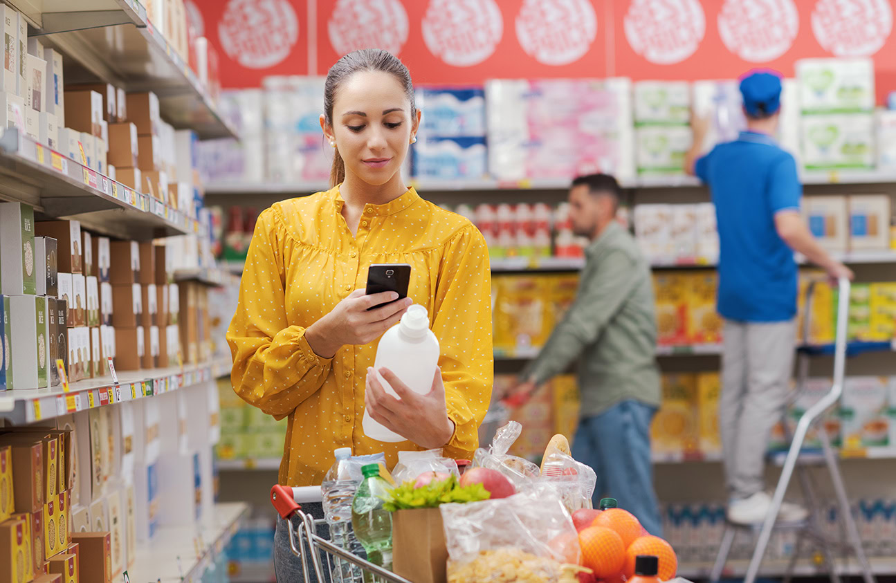 woman scanning product label with augmented reality app on phone in store