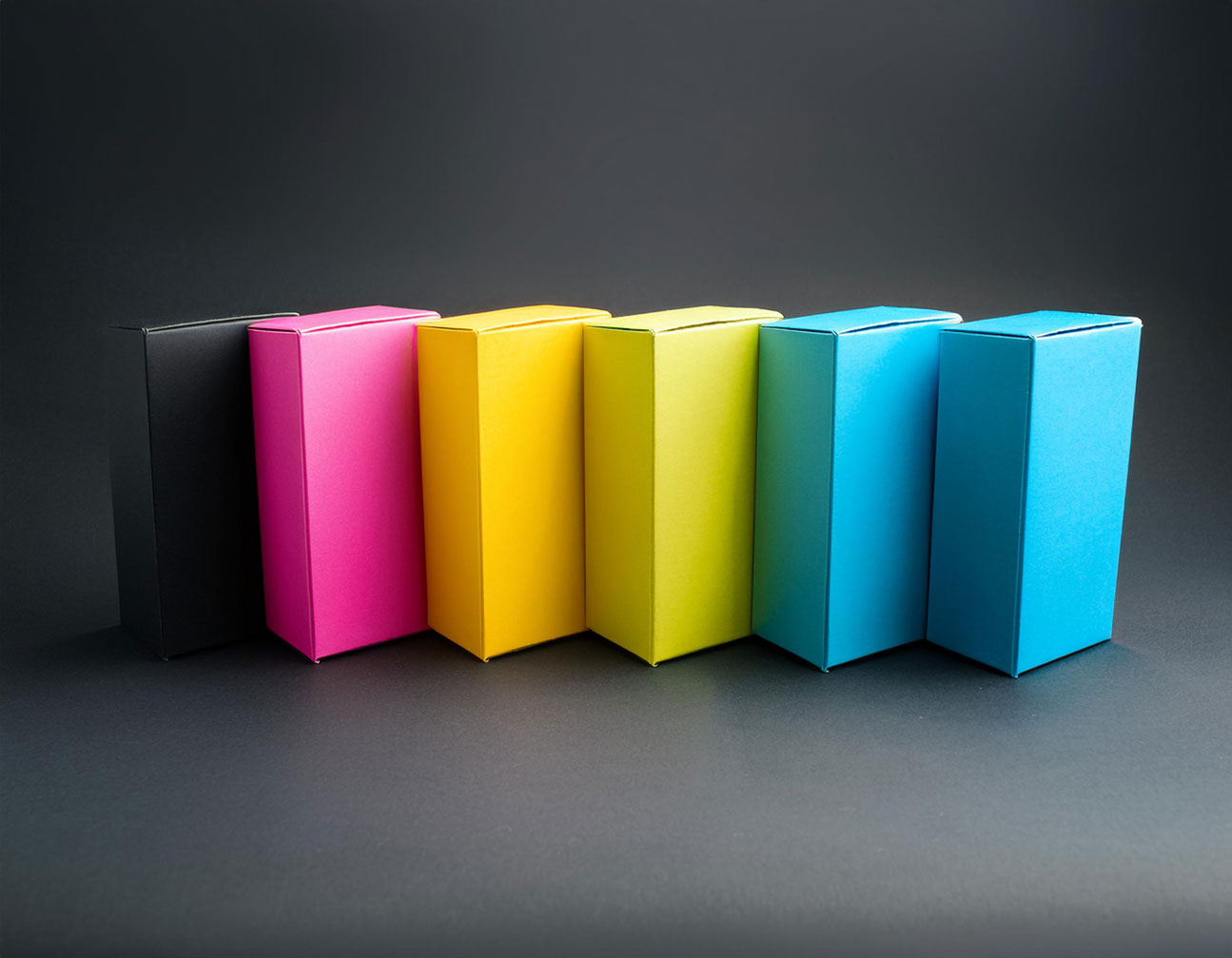 Product boxes in CMYK color spectrum in a line